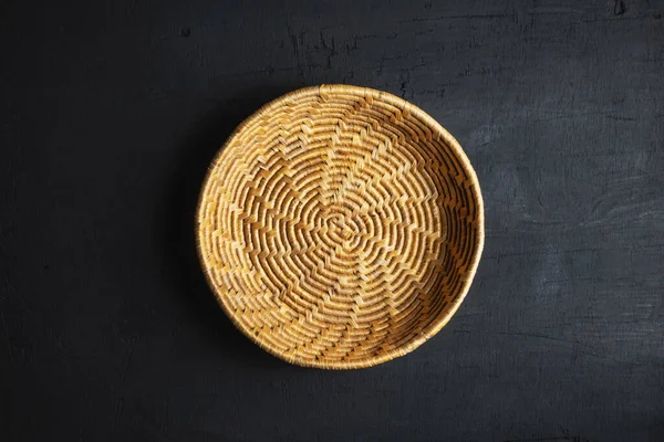 A wooden basket on a black background