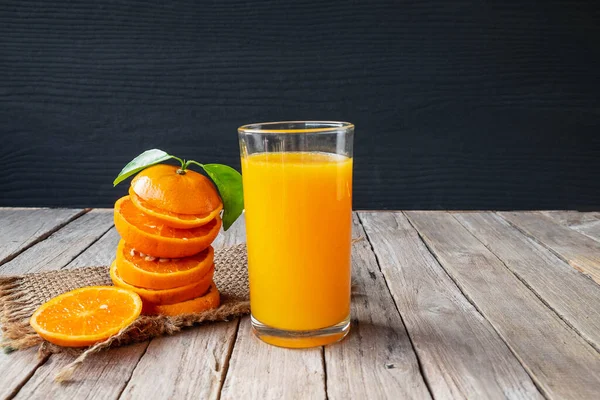 Fresh orange and orange juice on the table