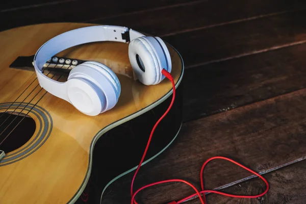 Classical guitar and music headphones