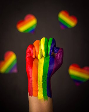 lgbtq topluluğu için gökkuşağı renginde yükseltilmiş bir yumruğun fotoğrafı.