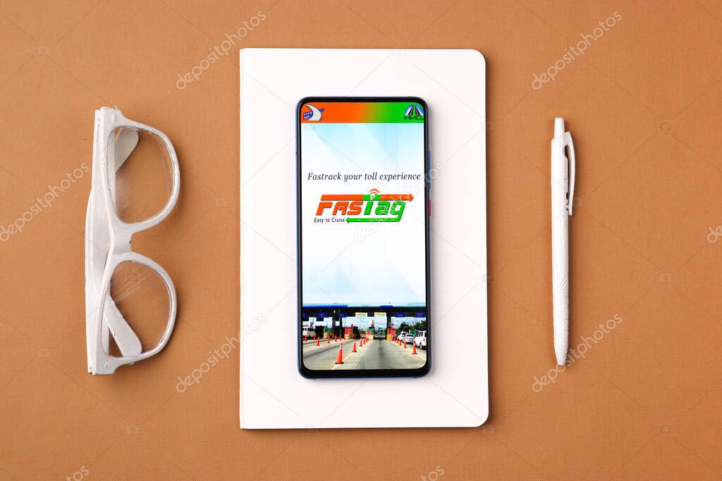 Assam, india - March 10, 2021 : FASTag logo on phone screen stock image.