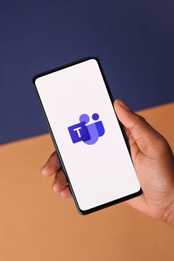 Microsoft takımlarının logosu telefon ekranı stok görüntüsü üzerinde.