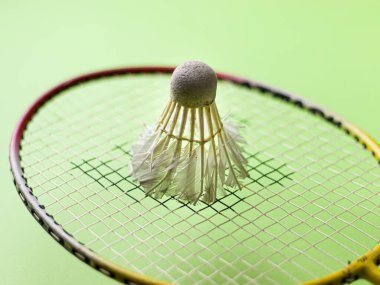 Badminton raketi ve beyaz tüylü Shuttlecock yeşil arkaplan stoğu görüntüsü izole. 