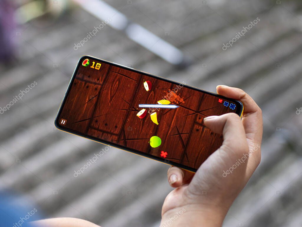 Assam, india - October 11, 2020 : Fruit ninja  logo on phone screen stock image.