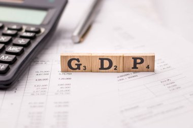 Assam, india - March 30, 2021 : Word GDP written on wooden cubes stock image. clipart