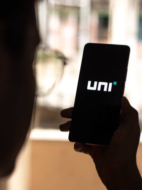 West Bangal, India - December 15, 2021 : Uni cards logo on phone screen stock image.