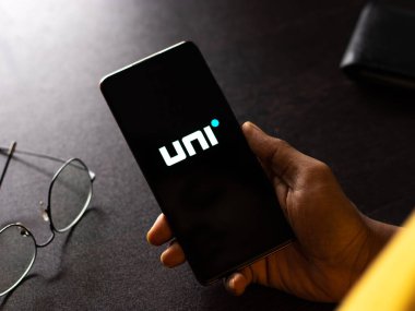 West Bangal, India - December 15, 2021 : Uni cards logo on phone screen stock image.