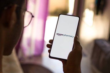 West Bangal, India - December 05, 2021 : Amazon Pharmacy logo on phone screen stock image.