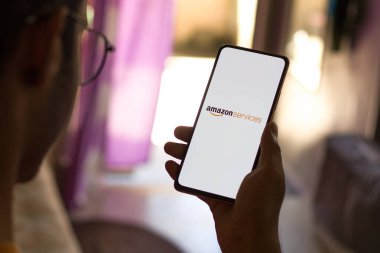 West Bangal, India - December 05, 2021 : Amazon service logo on phone screen stock image.