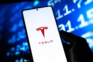 West Bangal, India - April 20, 2022 : Tesla on phone screen stock image.