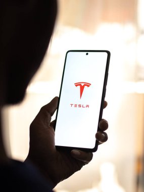 West Bangal, India - April 20, 2022 : Tesla on phone screen stock image.