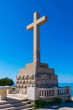 The Homeland War Memorial atop Mt. Srd stands out against a clear blue sky above Dubrovnik, Croatia