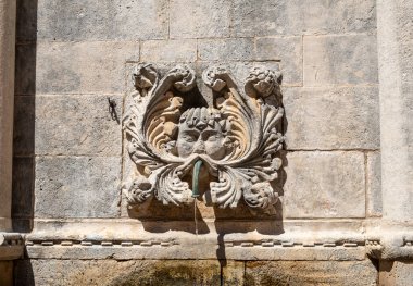 A single mask surronds one of the spigots of Large Onofrio's Fountain in Old Town Dubrovnik