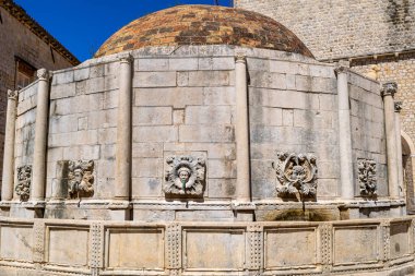 Horizontal panoramic view of Onofrio's fountain masks in Old Town Dubrovnik Croatia