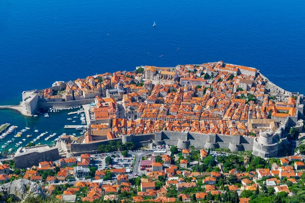 Colorful view of historic Old Town Dubrovnik framed by the blue waters of the adriatic.
