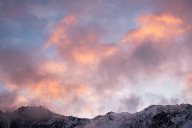 Güneşin doğuşundaki güzel kış dağları manzarası. Yoğun kar sisli dağları kapladı. Georgia, Kazbegi.