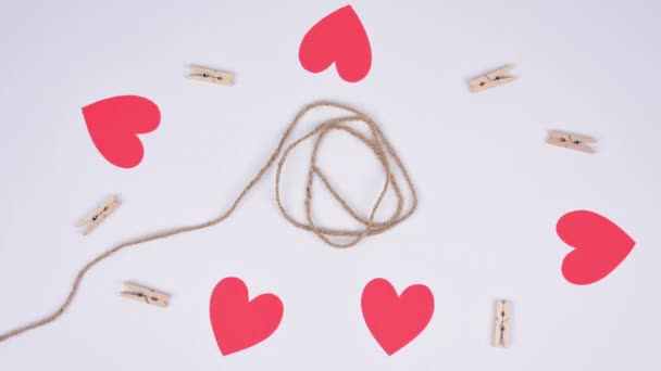 Stop Motion Red Paper Hearts Fixed Clothespins Cord White Background — 图库视频影像
