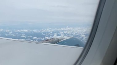 Airplane flight. Wing of an airplane flying above the clouds.