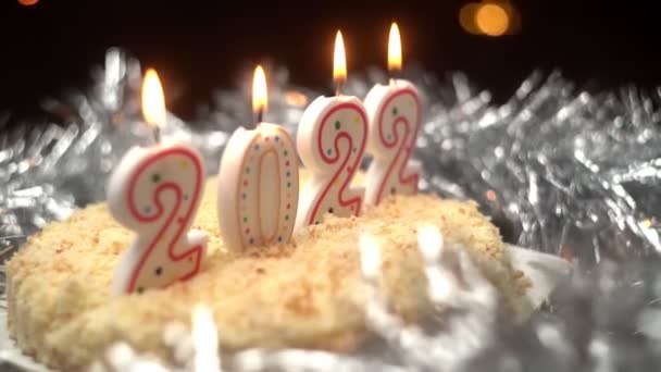Pastel de Navidad decorado con velas ardientes en forma de Año Nuevo 2022. — Vídeos de Stock