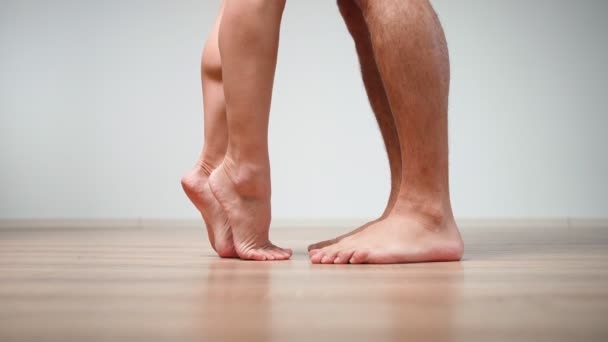 Close-up. A loving married couple barefoot approach each other and hug — Wideo stockowe