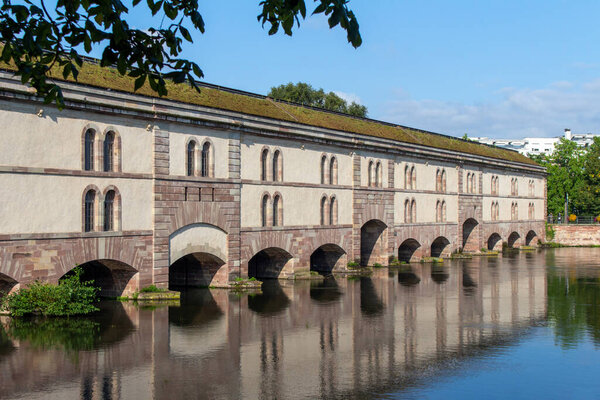Landscape view of the Barrage Vauban, a defensive city dam structure on the Ill River, originally known as the Grande Ecluse (Great Lock) in the city of Strasbourg, France