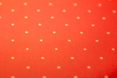 Full frame abstract texture background of solid red and yellow polka dots pattern with selective focus