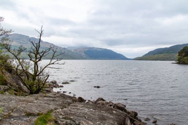 Scenic landscape view of the rocky shore of Loch Lomond in Scotland