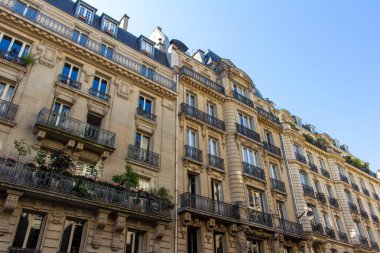 Close up exterior view of traditional building architecture in France, with beautiful ornate balconies