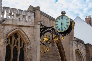 Close up view of a beautiful modern style clock on the medival stone walls surrounding the city of York, England