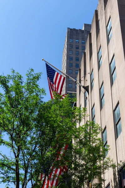 Close up view of an American flag displayed on a Manhattan building exterior in New York City