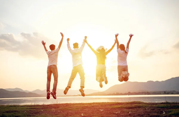 A group of Asian friends backpacker and walking for picnic and camping and and Raise your hand cheerful excitement