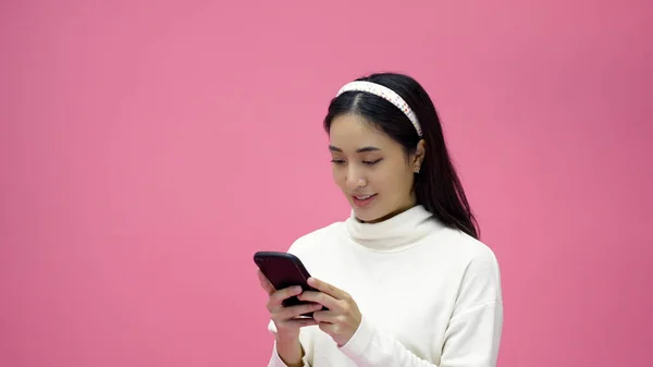 아시아 여성이 웃으며 태블릿으로 휴대폰을 사용하며 외롭게 배경으로 온라인 쇼핑을 — 스톡 사진