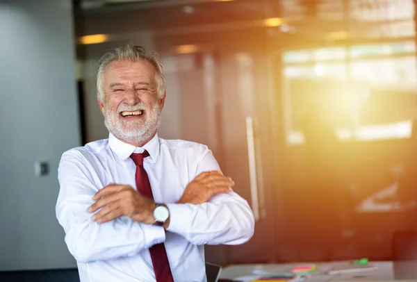 stock image Elderly business man standing confidently smiling and laughing happy in the meeting room