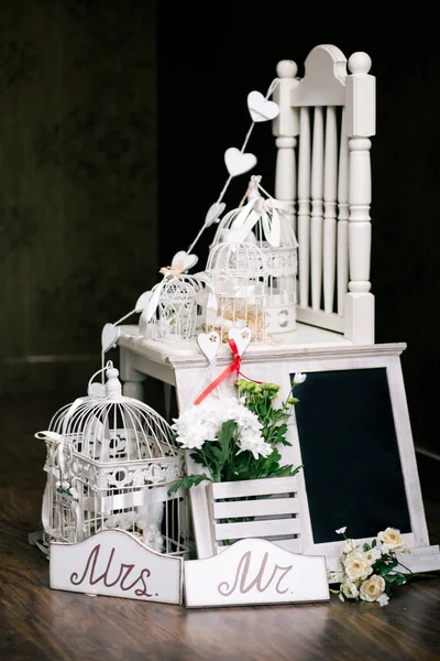 Bird cages on the chair. — Stock Photo, Image