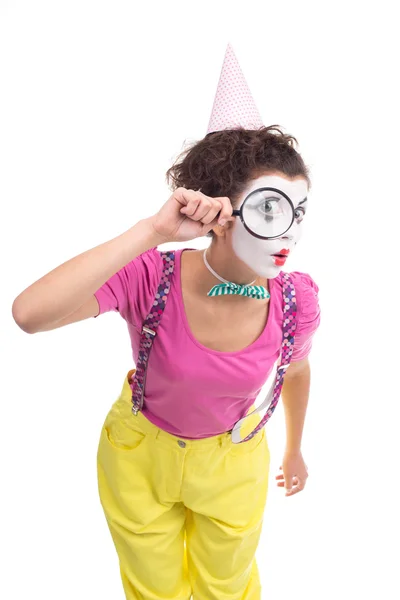 Clown looking in magnifying glass — Stock Photo, Image