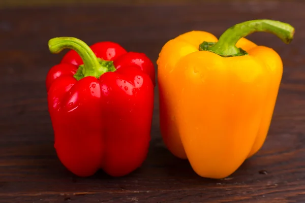 Peppers on wooden background — Stock Photo, Image