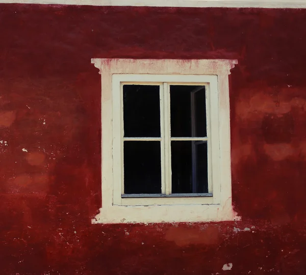 Decorative white window on an old red wall — Stock Photo, Image