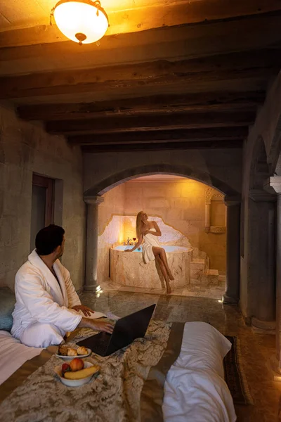 A couple man and woman in the old cave room of Cappadocia with bath morning breakfast - honeymoon vacation