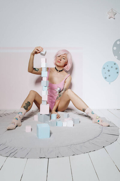 Sensual Young Tattooed Woman Pink Hair Style Wooden Blocks Stock Photo