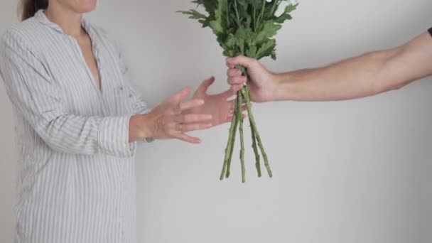 Von Händen mit einem Blumenstrauß, ein Mann reicht einer Frau einen Strauß weißer Chrysanthemen. — Stockvideo