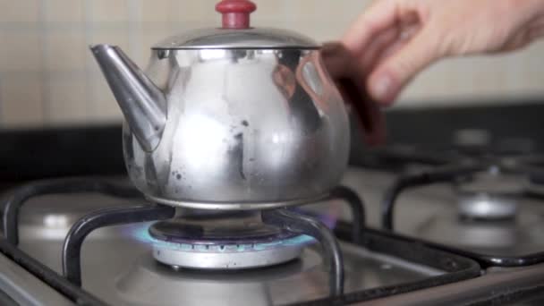 Close Womans Hand Puts Kettle Water Gas Burner — Stock Video