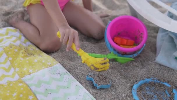 女の子はトルコのビーチで夏に砂のおもちゃで遊ぶ — ストック動画