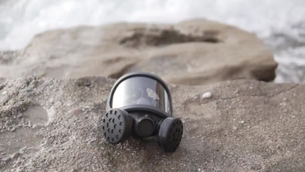 Gas Mask Lies Rock Sea Cloudy Day — Stock Video