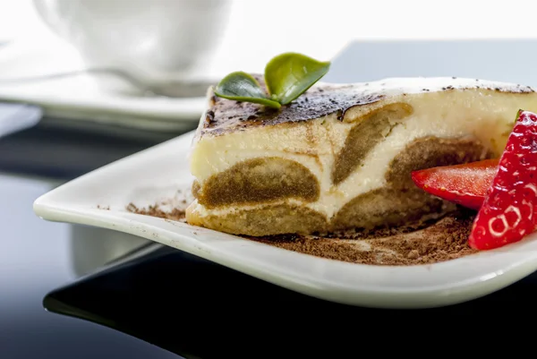 Tiramisu on black reflex background — Stock Photo, Image