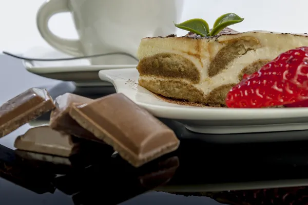 Tiramisu on black reflex background — Stock Photo, Image