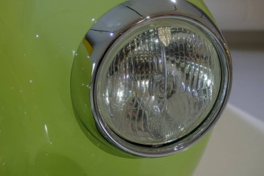headlight of a green retro car close-up. Car detail. Transportation. Car repair