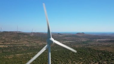 Rüzgar türbinleri dönüyor. Bu stok video türbinleri bir rüzgar çiftliğinde hava perspektifinden gösteriyor..