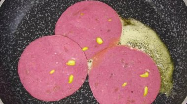 Cooking. Salami And Eggs. Cooking. slices of salami falling into the pan where the butter is melted, followed by the egg
