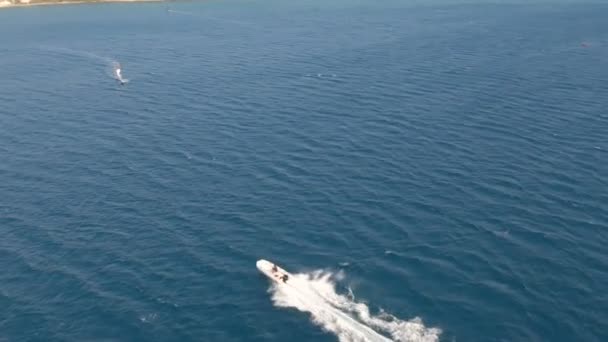 Wind Surfers Speedboat Action Aerial View Speeding Windsurfers Powerboat Aerial — стоковое видео