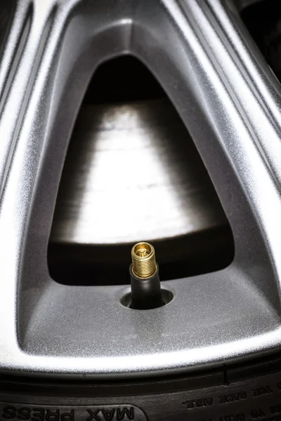 Close-up of a tire valve on car wheel. — Stock Photo, Image